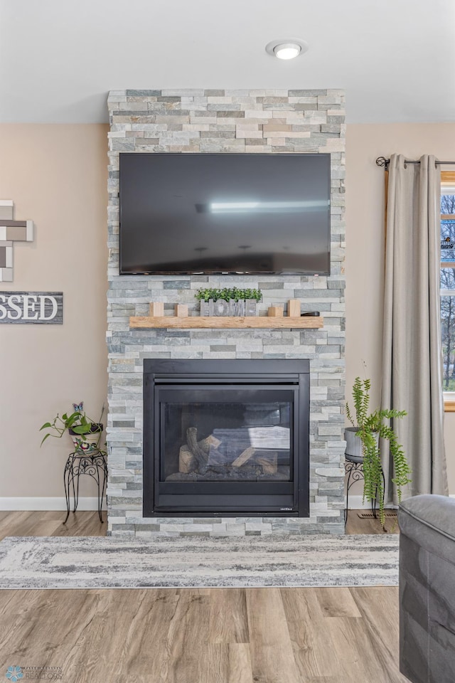 15344 Blackhawk Rd, Lake Eunice Twp, MN 56511 - detailed view of a stone fireplace, wood finished floors, and baseboards