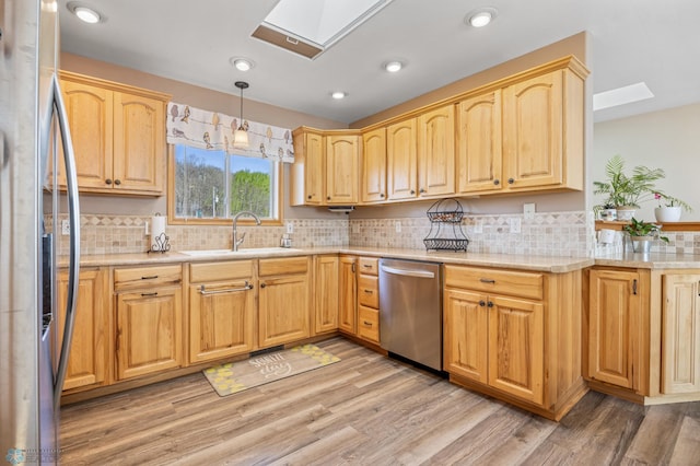 15344 Blackhawk Rd, Lake Eunice Twp, MN 56511 - kitchen featuring stainless steel appliances, a skylight, a sink, light wood finished floors, and recessed lighting