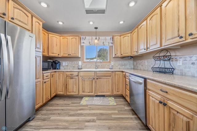 15344 Blackhawk Rd, Lake Eunice Twp, MN 56511 - kitchen with appliances with stainless steel finishes, a sink, light brown cabinets, light countertops, and tasteful backsplash