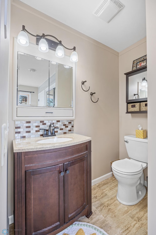 15344 Blackhawk Rd, Lake Eunice Twp, MN 56511 - bathroom featuring tasteful backsplash, toilet, vanity, and baseboards