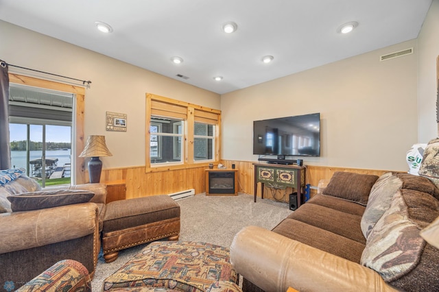 15344 Blackhawk Rd, Lake Eunice Twp, MN 56511 - living room featuring wainscoting, a baseboard heating unit, wood walls, carpet flooring, and a water view