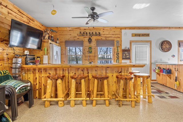 15344 Blackhawk Rd, Lake Eunice Twp, MN 56511 - indoor dry bar featuring wood walls, ceiling fan, and baseboards