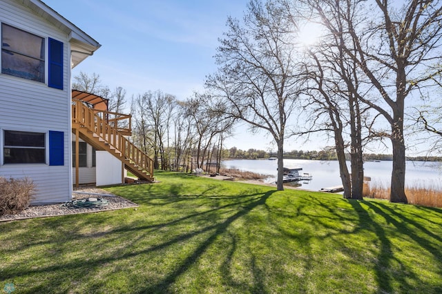 15344 Blackhawk Rd, Lake Eunice Twp, MN 56511 - view of grassy yard featuring stairs and a deck with water view