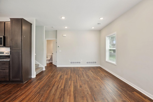 2219 Youngman Ave, Saint Paul, MN 55116 - unfurnished living room featuring visible vents, dark wood-style flooring, baseboards, and stairs