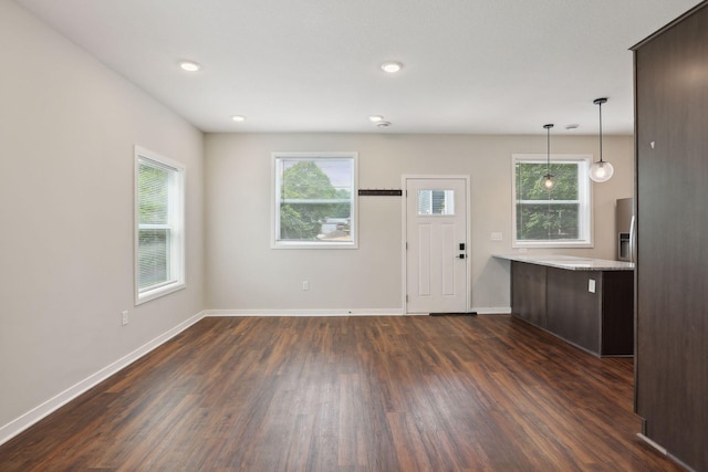 2219 Youngman Ave, Saint Paul, MN 55116 - unfurnished living room with dark wood-style flooring, baseboards, plenty of natural light, and recessed lighting