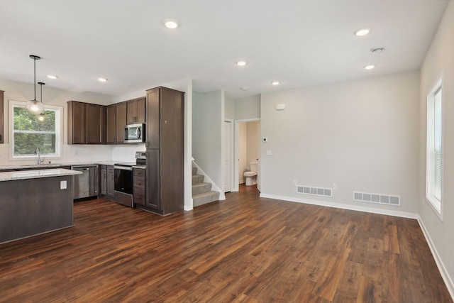 2219 Youngman Ave, Saint Paul, MN 55116 - kitchen featuring a sink, dark brown cabinetry, visible vents, and appliances with stainless steel finishes