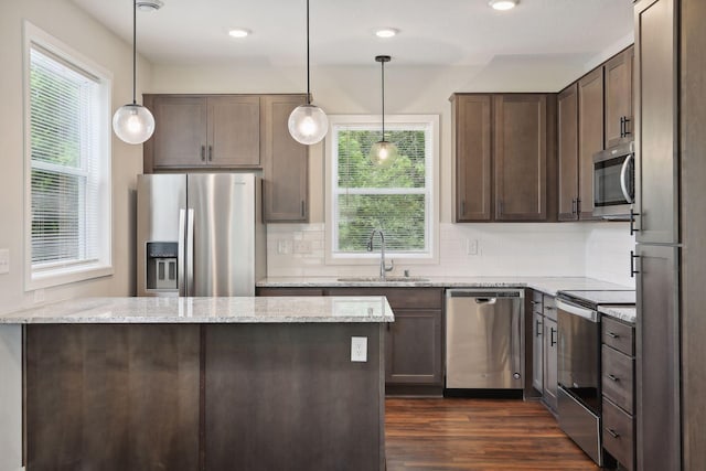 2219 Youngman Ave, Saint Paul, MN 55116 - kitchen featuring dark brown cabinets, plenty of natural light, appliances with stainless steel finishes, and a sink