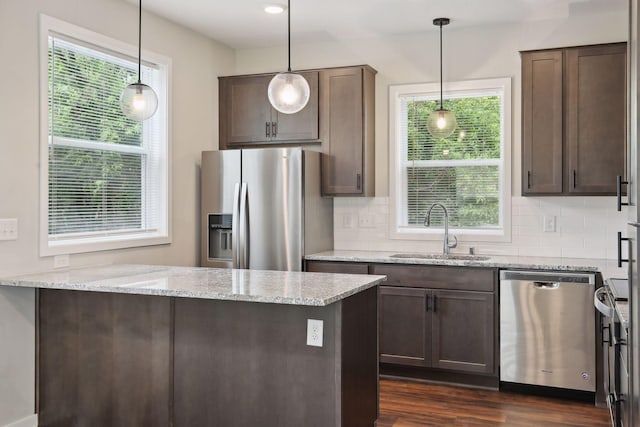 2219 Youngman Ave, Saint Paul, MN 55116 - kitchen with a sink, dark brown cabinetry, decorative backsplash, and appliances with stainless steel finishes