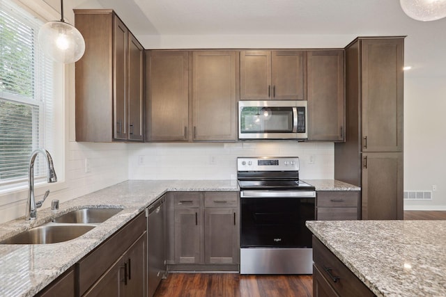 2219 Youngman Ave, Saint Paul, MN 55116 - kitchen with appliances with stainless steel finishes, visible vents, decorative backsplash, and a sink