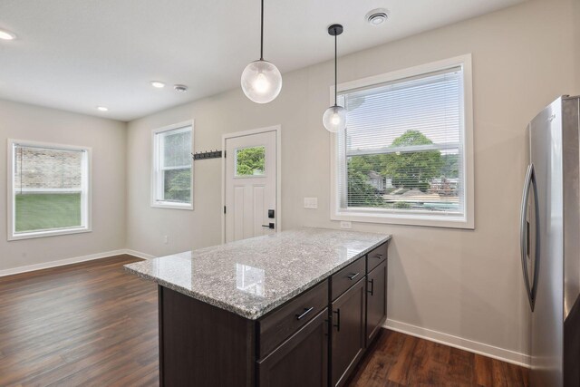 2219 Youngman Ave, Saint Paul, MN 55116 - kitchen with a peninsula, freestanding refrigerator, dark brown cabinetry, dark wood-style flooring, and baseboards