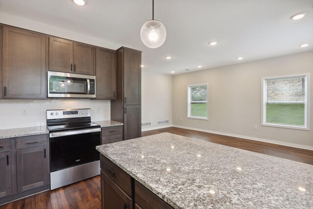 2219 Youngman Ave, Saint Paul, MN 55116 - kitchen featuring dark wood-style flooring, stainless steel appliances, tasteful backsplash, and visible vents