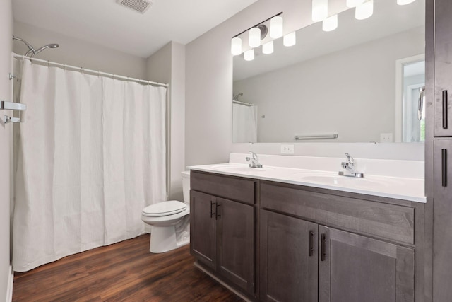 2219 Youngman Ave, Saint Paul, MN 55116 - full bath featuring a sink, double vanity, toilet, and visible vents