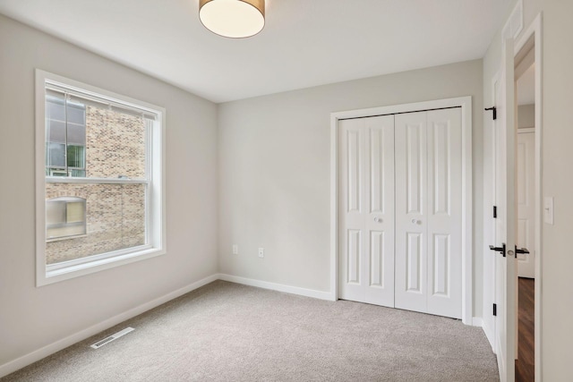 2219 Youngman Ave, Saint Paul, MN 55116 - unfurnished bedroom featuring baseboards, carpet flooring, a closet, and visible vents