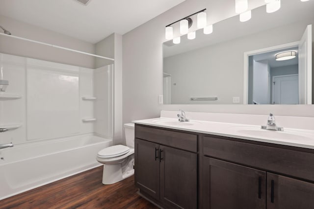 2219 Youngman Ave, Saint Paul, MN 55116 - bathroom featuring toilet, double vanity, a sink, and wood finished floors