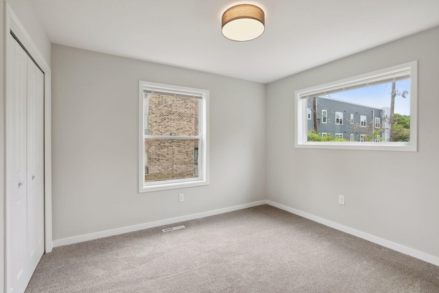 2219 Youngman Ave, Saint Paul, MN 55116 - unfurnished bedroom with carpet floors, a closet, baseboards, and visible vents