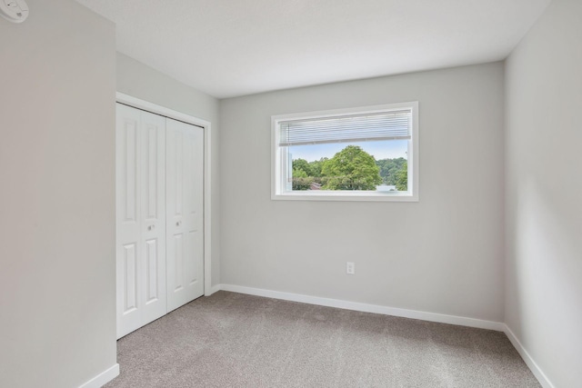 2219 Youngman Ave, Saint Paul, MN 55116 - unfurnished bedroom with carpet flooring, a closet, and baseboards