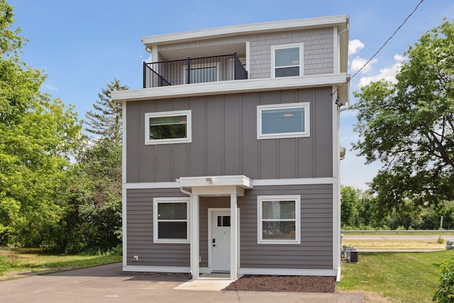 2219 Youngman Ave, Saint Paul, MN 55116 - view of front of property featuring a balcony, board and batten siding, central AC, and a front lawn