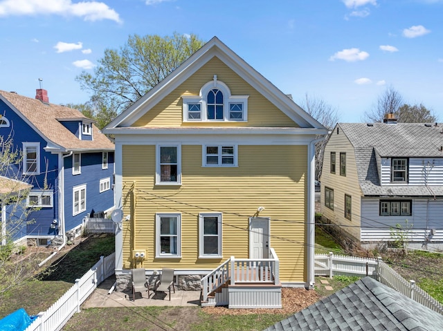 rear view of house with a patio area and a fenced backyard