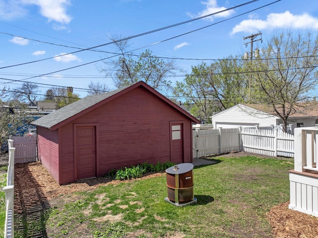 view of yard with an outdoor structure and a fenced backyard