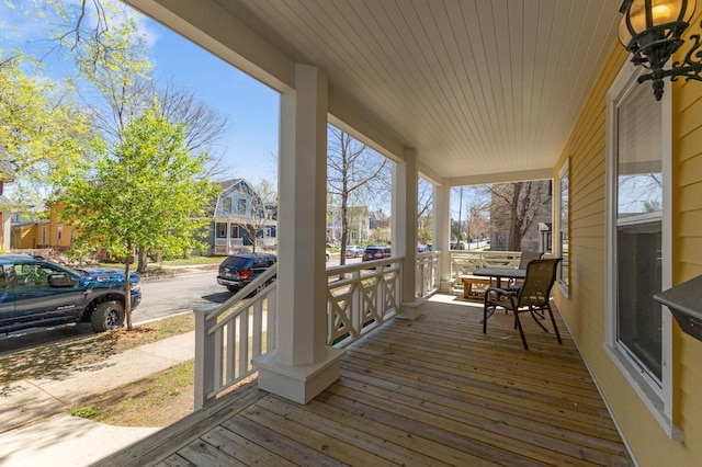 deck with a porch and a residential view
