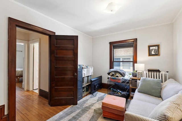 interior space featuring baseboards, light wood finished floors, and crown molding