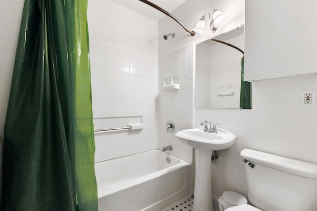 bathroom with a sink, toilet, and shower / bath combo