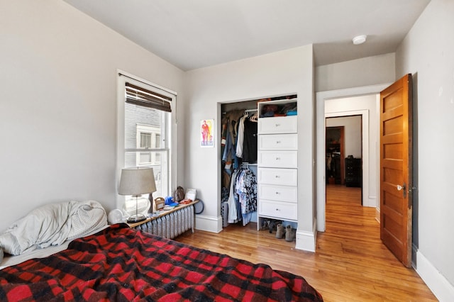 bedroom featuring light wood-style flooring and baseboards