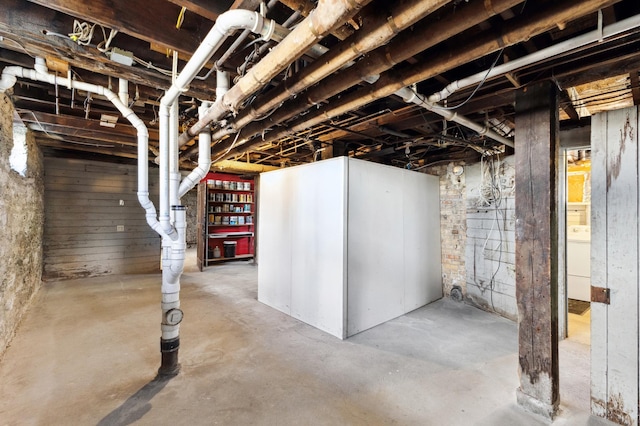 unfinished basement featuring washer / dryer