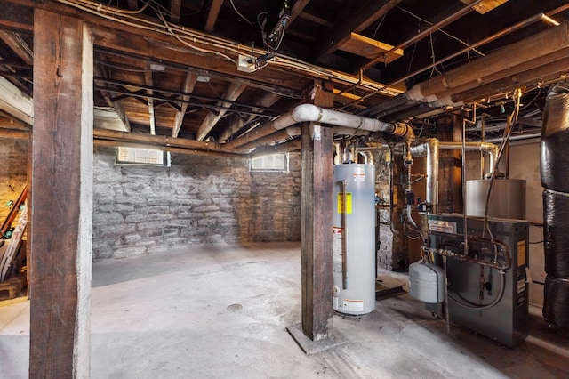 basement featuring water heater and gas water heater