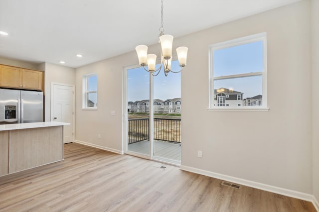 6742 Wildflower Way, Minnetrista, MN 55331 - unfurnished dining area with baseboards, a chandelier, light wood finished floors, and recessed lighting