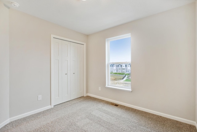 6742 Wildflower Way, Minnetrista, MN 55331 - unfurnished bedroom with carpet, baseboards, and a closet