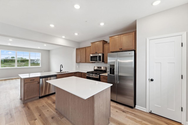 6742 Wildflower Way, Minnetrista, MN 55331 - kitchen featuring appliances with stainless steel finishes, a peninsula, light wood-style floors, backsplash, and recessed lighting