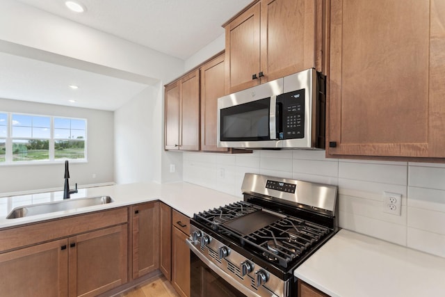 6742 Wildflower Way, Minnetrista, MN 55331 - kitchen with stainless steel appliances, decorative backsplash, light countertops, and recessed lighting