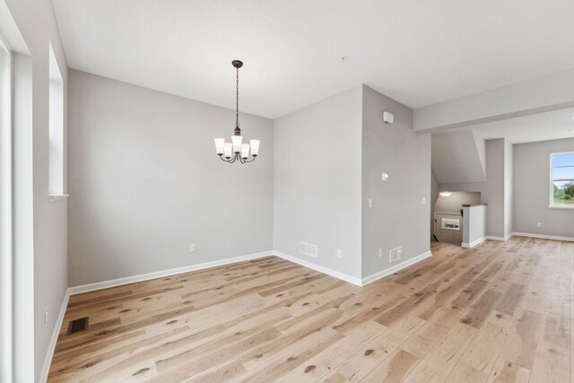 6742 Wildflower Way, Minnetrista, MN 55331 - spare room featuring light wood-style floors and a chandelier
