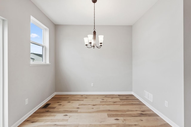 6742 Wildflower Way, Minnetrista, MN 55331 - spare room featuring a chandelier and light wood finished floors