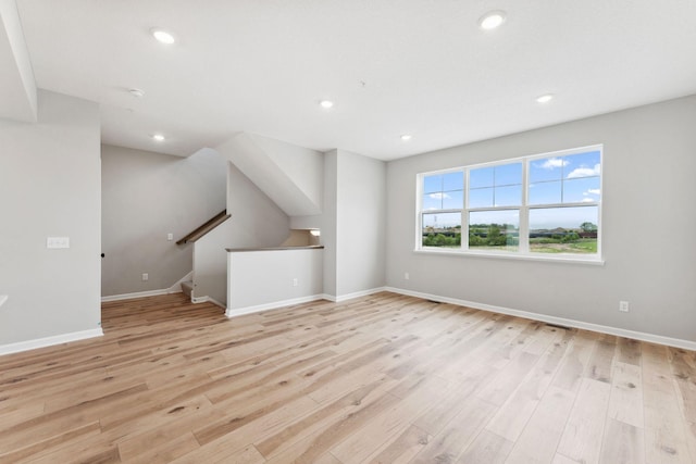 6742 Wildflower Way, Minnetrista, MN 55331 - unfurnished room with light wood-style flooring, recessed lighting, a smoke detector, and stairway