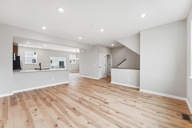 6742 Wildflower Way, Minnetrista, MN 55331 - unfurnished living room featuring light wood-style flooring and recessed lighting