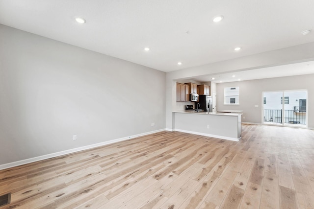 6742 Wildflower Way, Minnetrista, MN 55331 - unfurnished living room featuring light wood-style flooring and recessed lighting