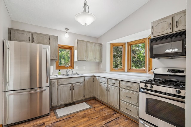 6913 Sumac Ct, Centerville, MN 55038 - kitchen featuring stainless steel appliances, light countertops, lofted ceiling, dark wood-style flooring, and gray cabinetry