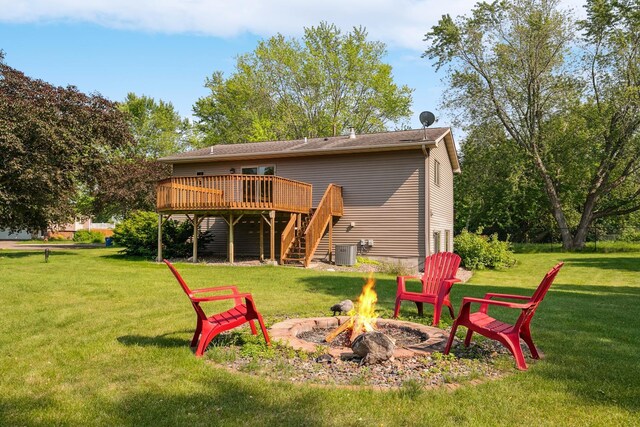 6913 Sumac Ct, Centerville, MN 55038 - back of property with a fire pit, stairs, a deck, and a lawn