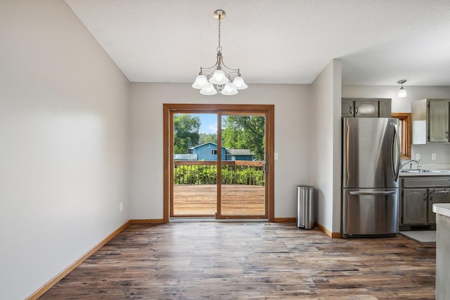 6913 Sumac Ct, Centerville, MN 55038 - unfurnished dining area featuring a chandelier and dark wood-style flooring