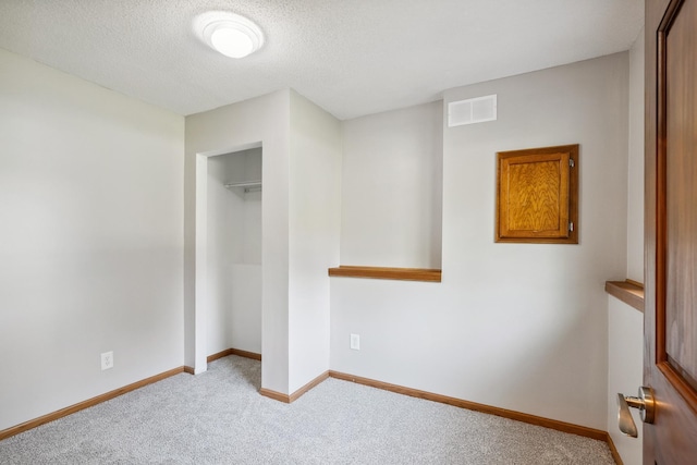 6913 Sumac Ct, Centerville, MN 55038 - unfurnished bedroom featuring carpet, a closet, and a textured ceiling