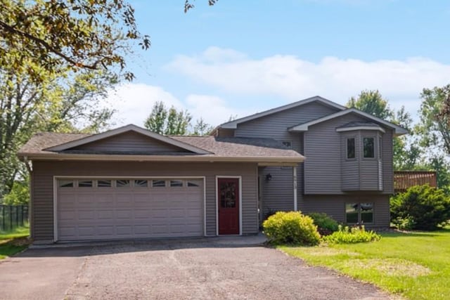 6913 Sumac Ct, Centerville, MN 55038 - tri-level home with an attached garage, a front lawn, and driveway
