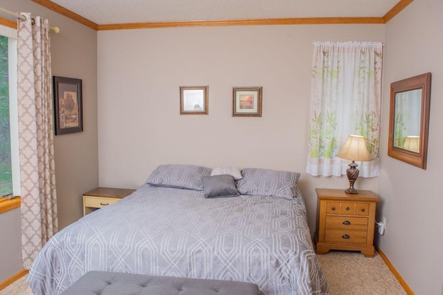 bedroom with carpet flooring, crown molding, and baseboards