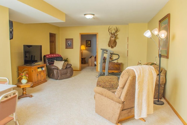 carpeted living area featuring baseboards