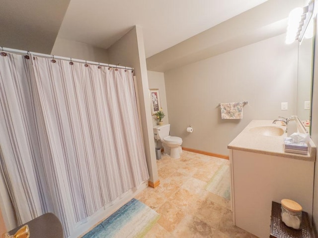 bathroom featuring toilet, vanity, a shower with curtain, tile patterned floors, and baseboards