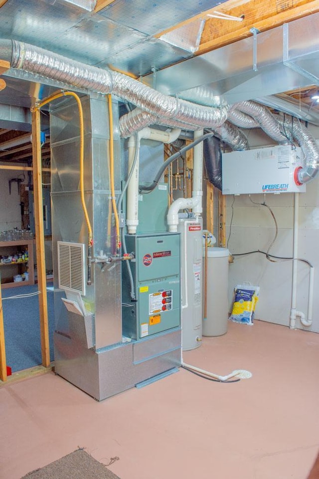 utility room featuring water heater and heating unit