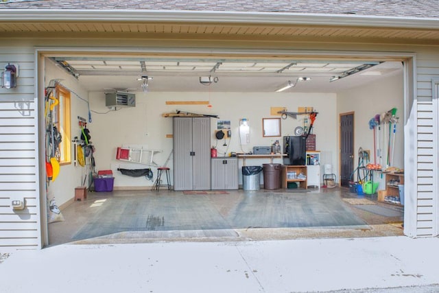 garage featuring freestanding refrigerator and a workshop area