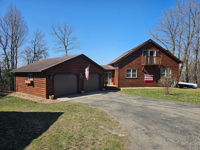 19319 Elsie Way NW, Bemidji, MN 56601 - log home featuring aphalt driveway, a front lawn, log veneer siding, and an attached garage