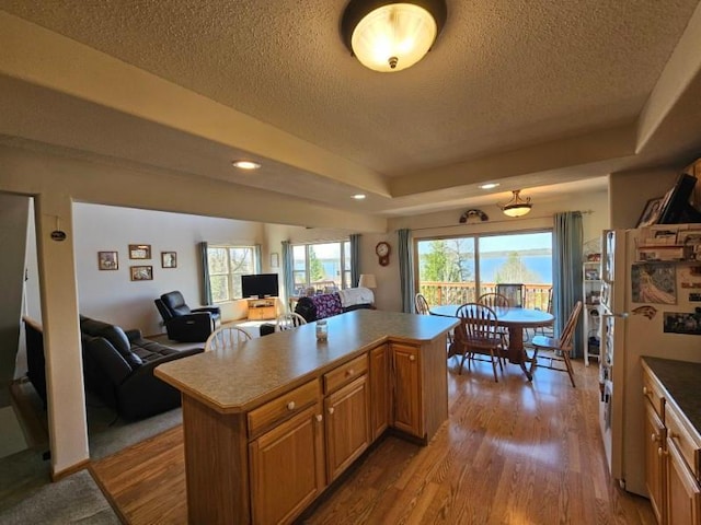 19319 Elsie Way NW, Bemidji, MN 56601 - kitchen featuring a textured ceiling, a center island, wood finished floors, and open floor plan